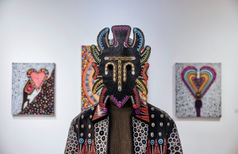 Adama Wearing a Wooden Mask