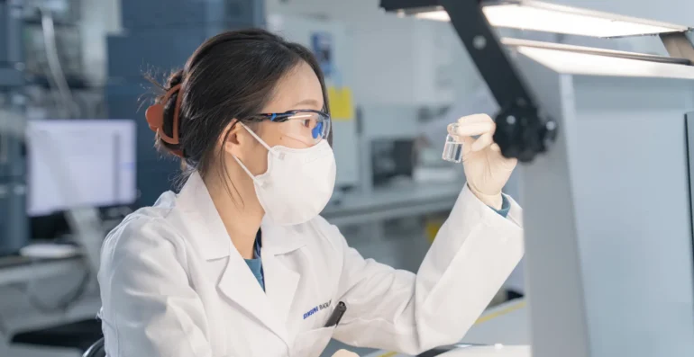 Scientist Examining a Vial